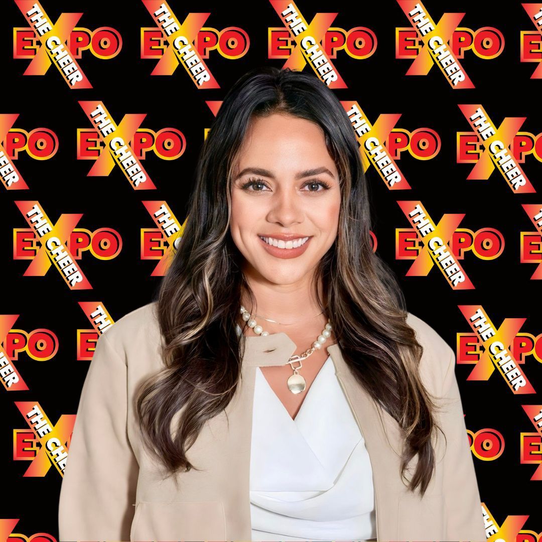 A woman is standing in front of a black background with the word expo on it.