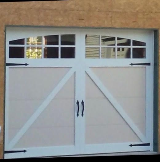 White garage door with glass panes and black hardware.