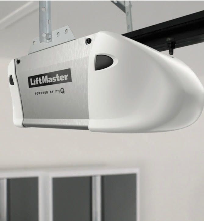 White LiftMaster garage door opener mounted to ceiling.