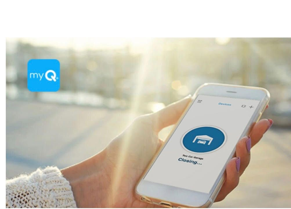 Hand holding smartphone, using the myQ app to close a garage door. Bright sunlight in background.