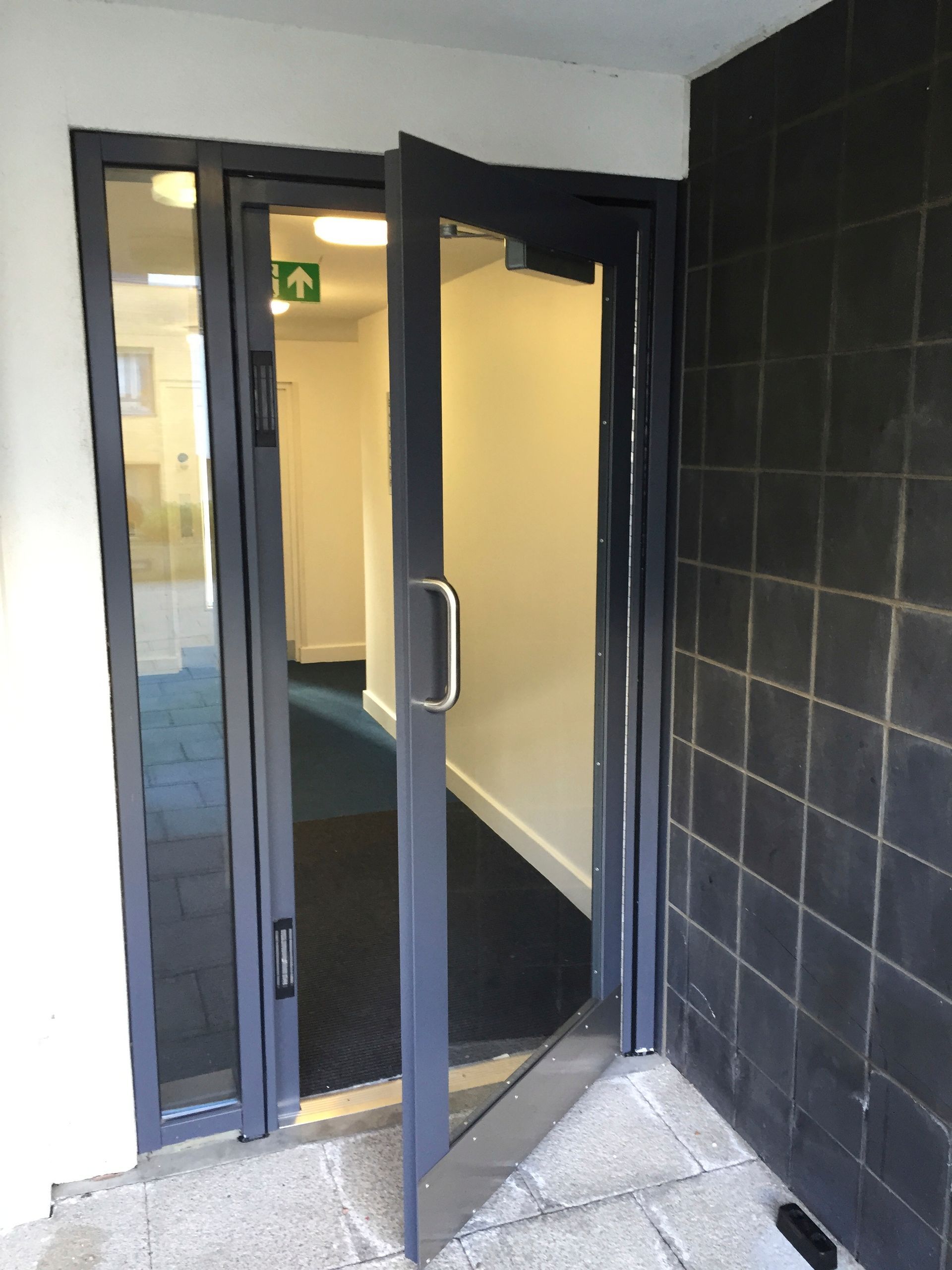 a door with a green exit sign above it