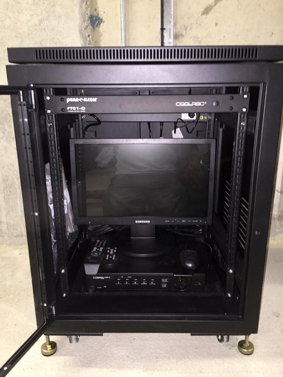 a samsung monitor sits on top of a rack