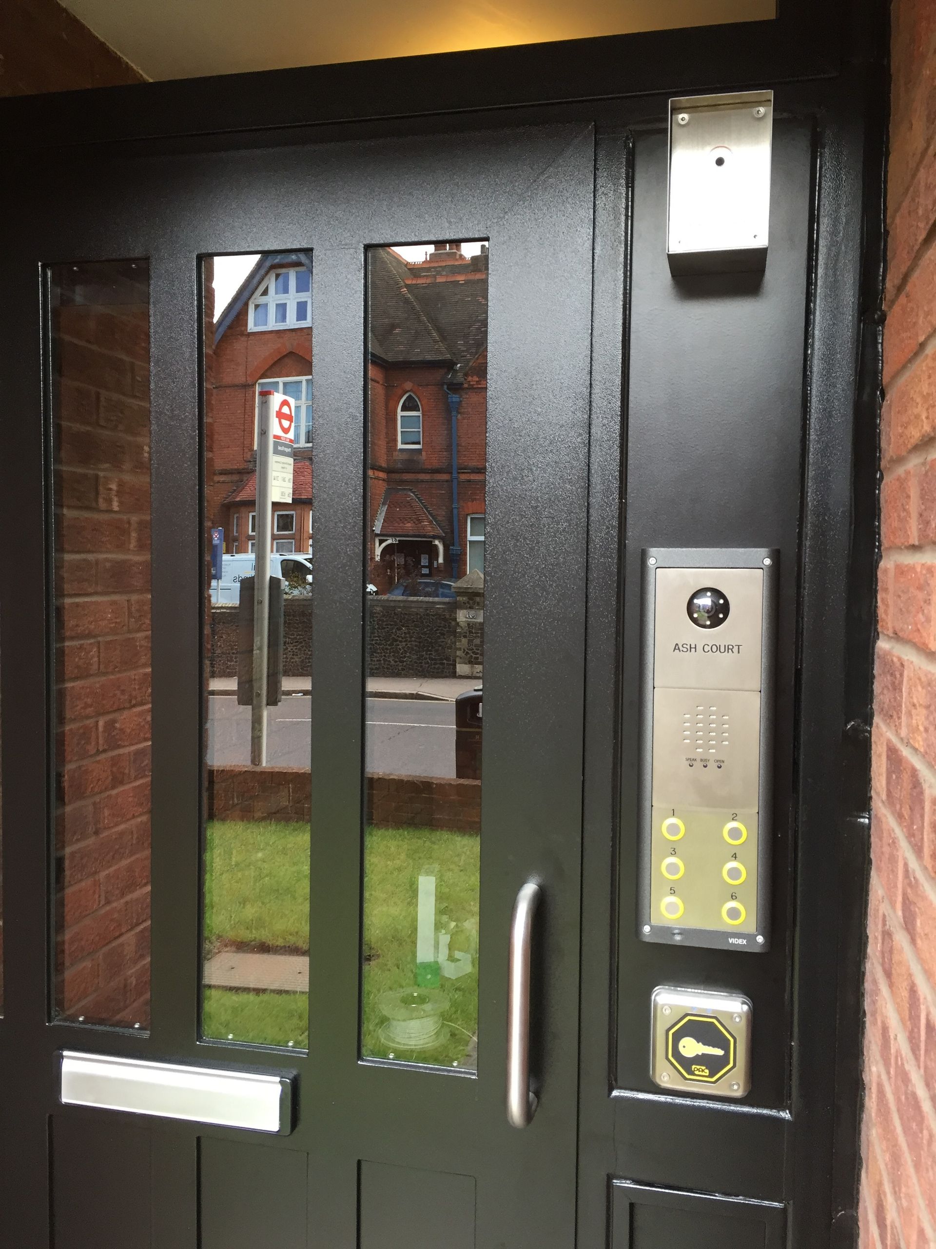 a black door with ash court written on it