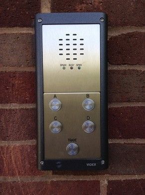 a video door phone is mounted on a brick wall .