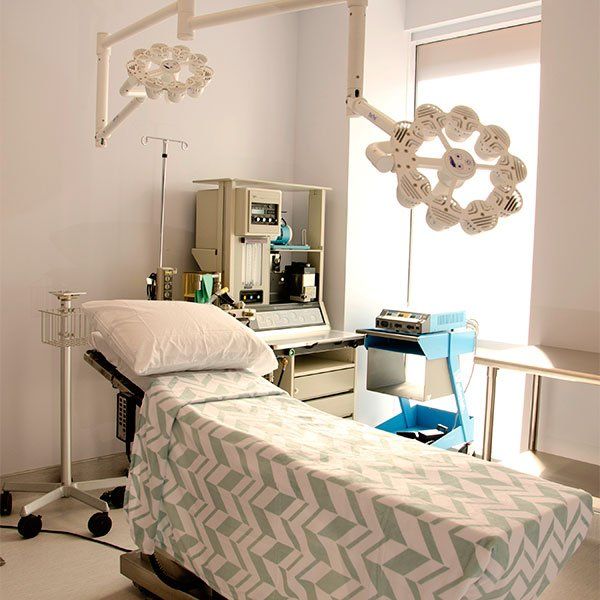 An operating room with a bed and a light