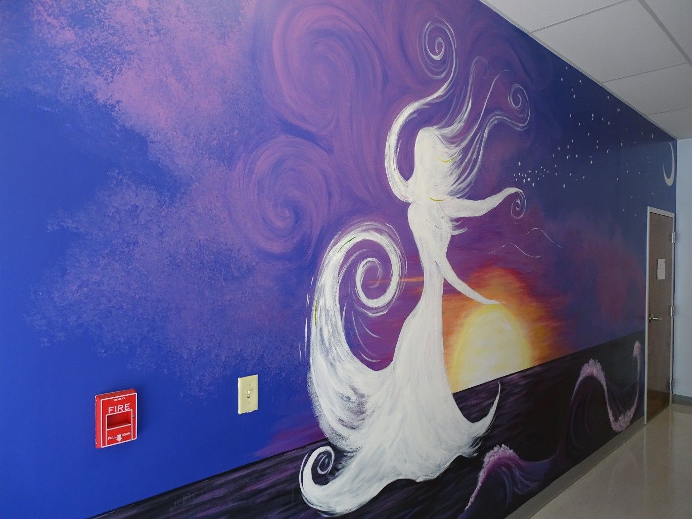 mural of ethereal woman on purple background in hallway of The Cosmetic Concierge office
