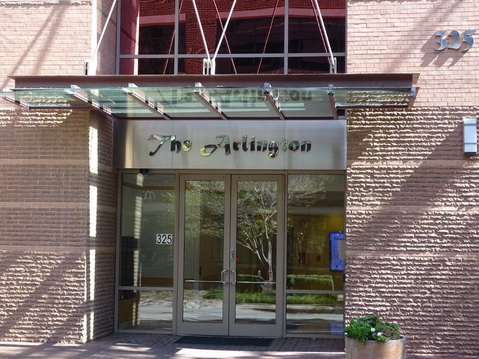 A brick building with a sign that says The Arlington