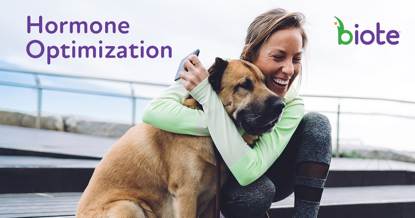 A woman is hugging a dog with the words hormone optimization in the background