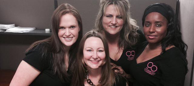 A group of four women are posing for a picture together.