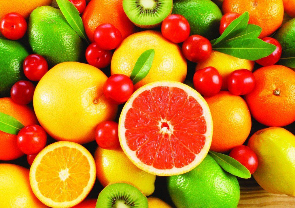 A bunch of different types of fruits are sitting on a table.