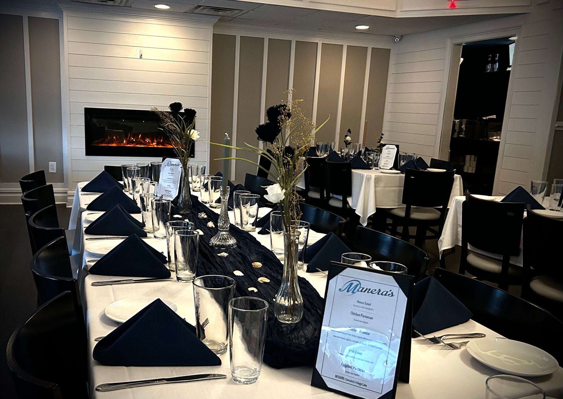 A restaurant with tables and chairs set up for a dinner party.