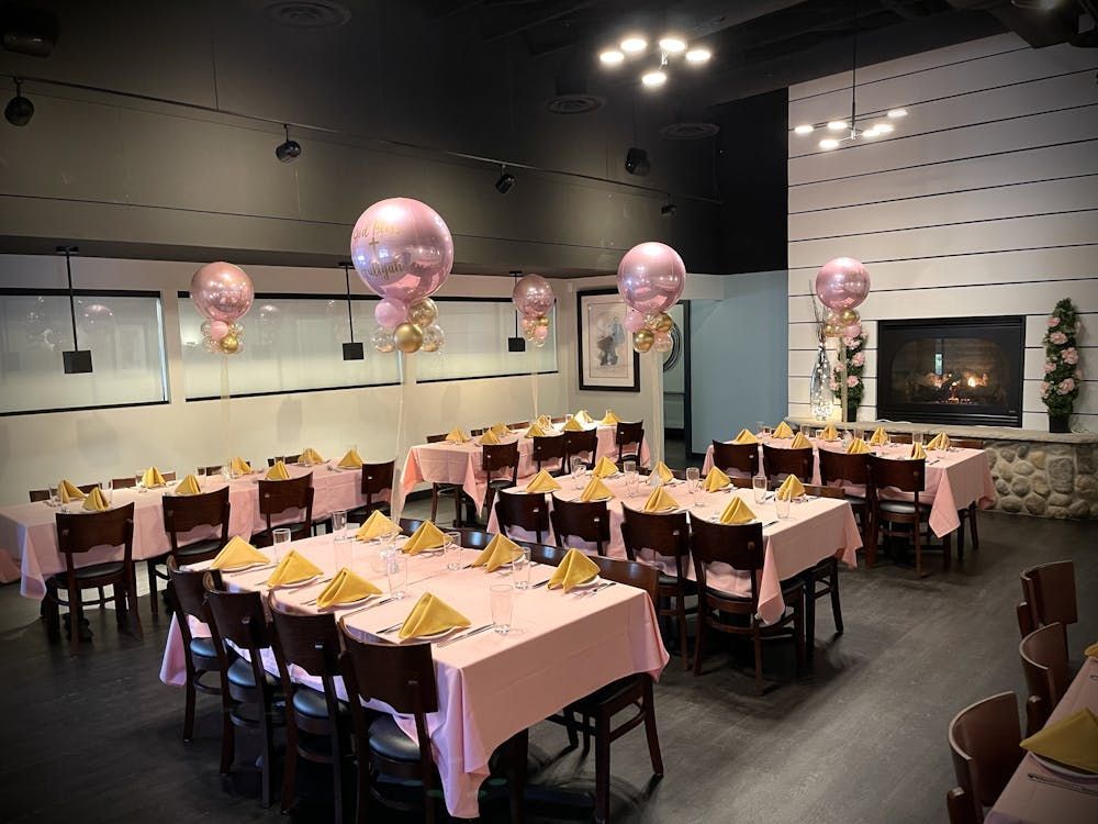 A restaurant filled with tables and chairs and balloons.