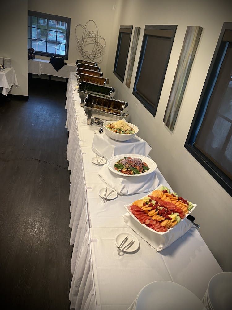 A long buffet table with a variety of food on it
