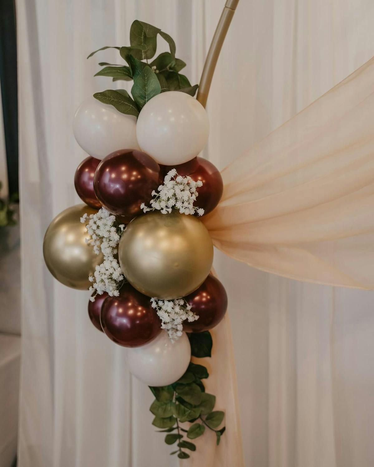 A bunch of balloons are hanging from a pole.