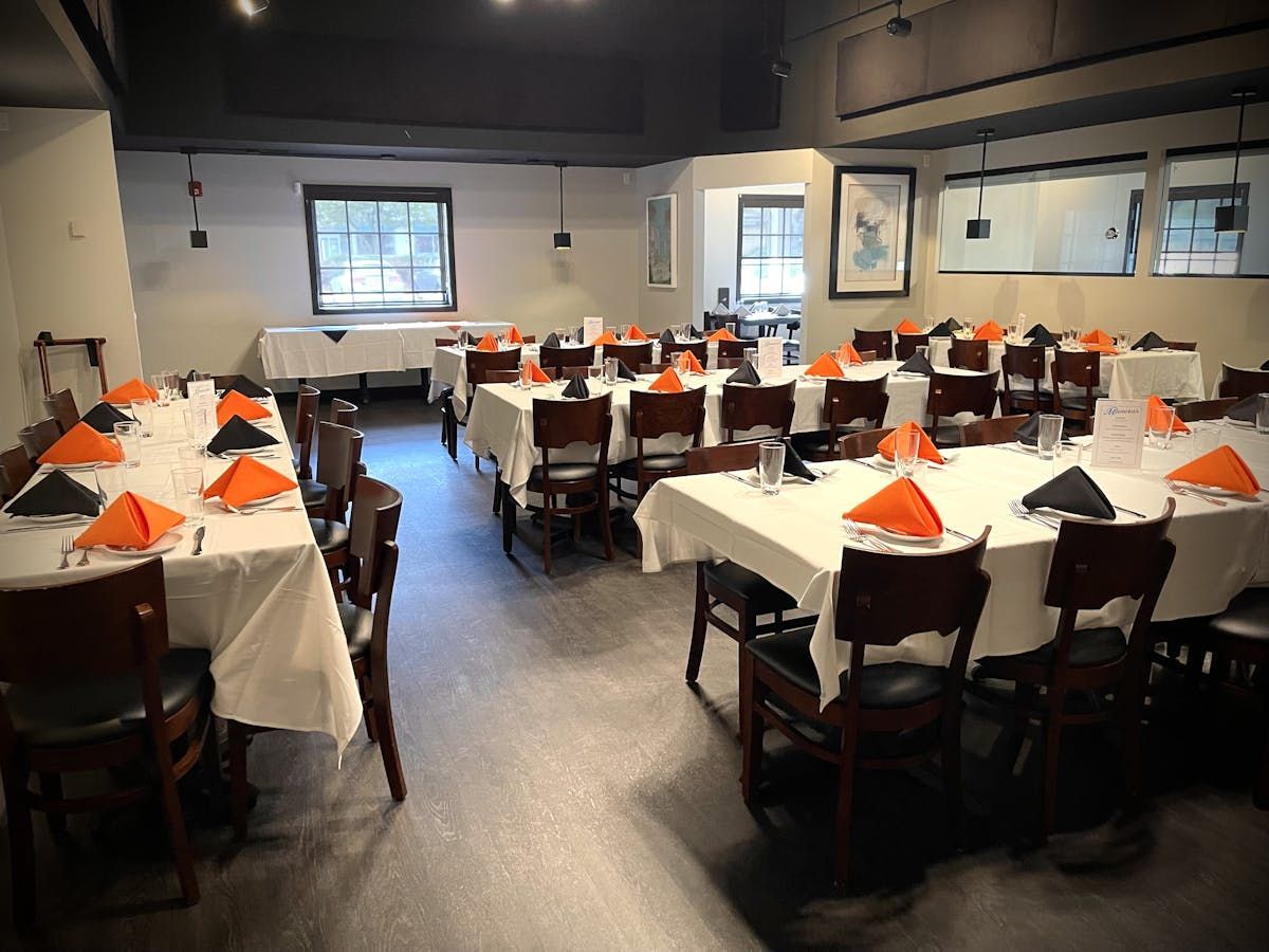 A restaurant with tables and chairs set up for a party