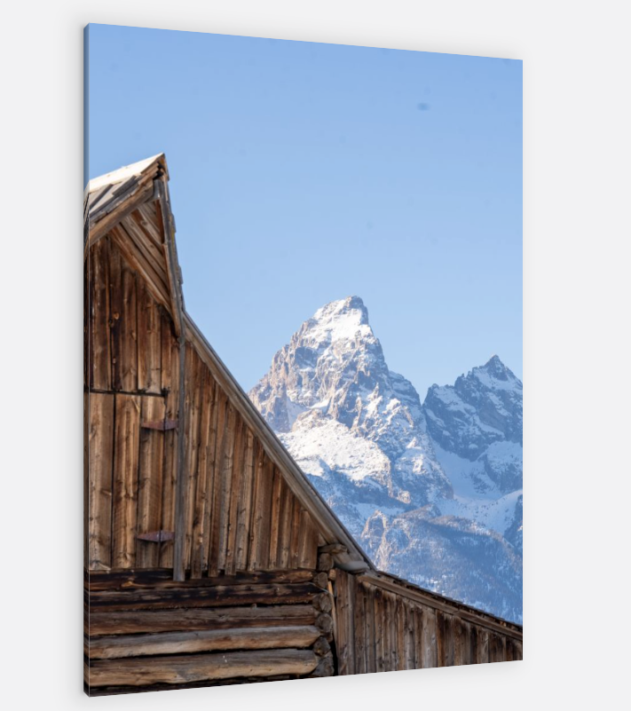 A wooden building with a mountain in the background