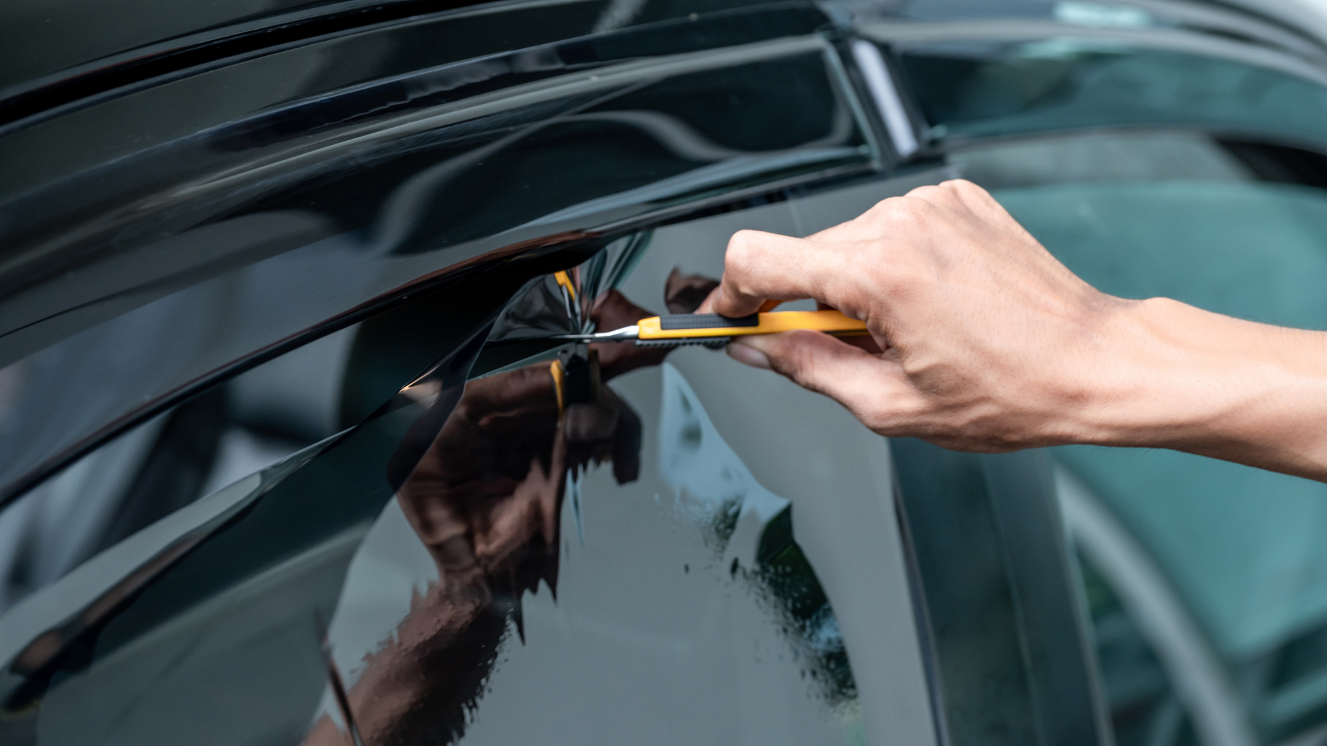 A close up of a car wheel with mud flaps on it.