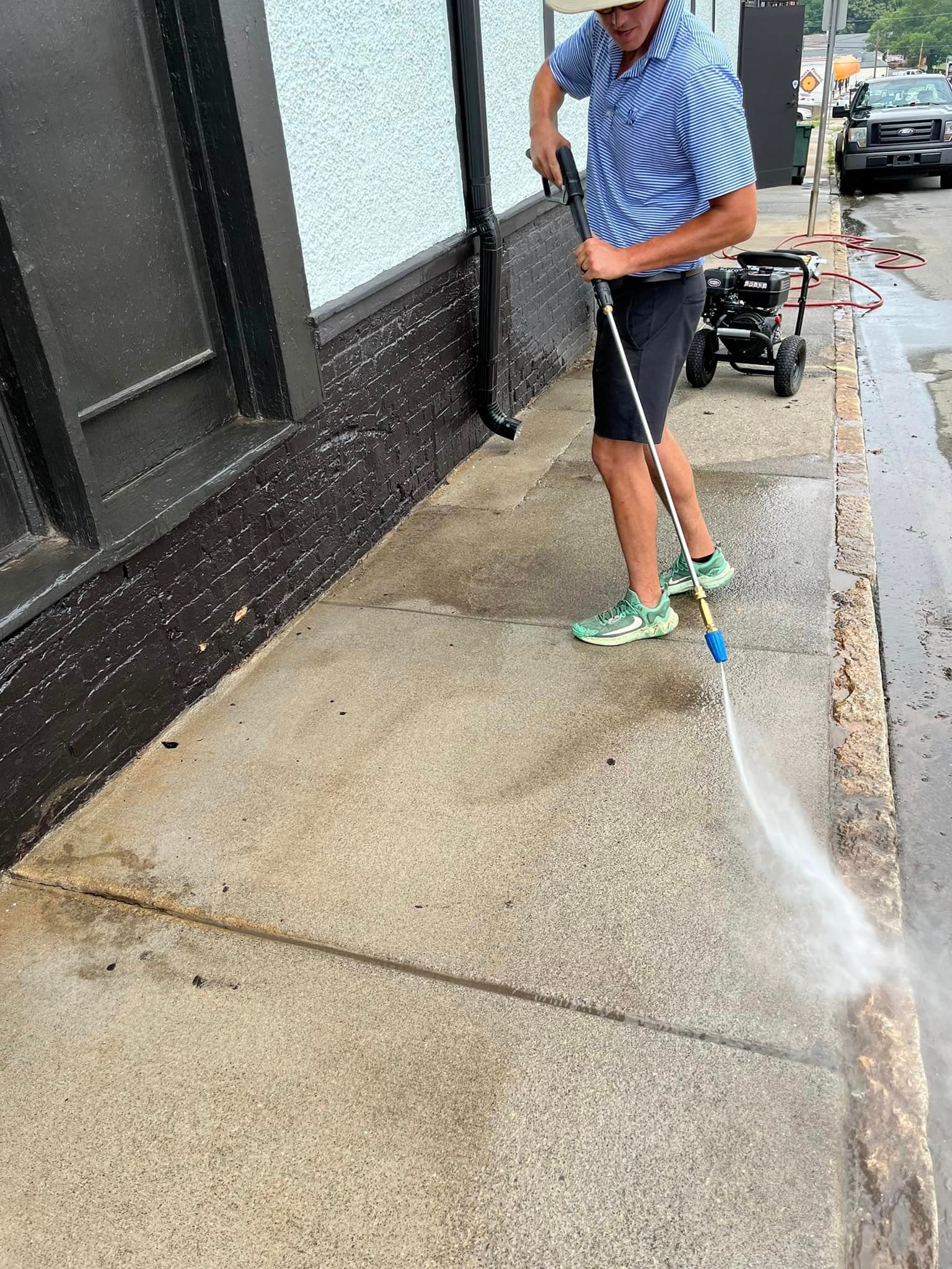 Man Using Pressure Washing in Front Yard Gardens — King, NC — Ram Outdoor Solutions