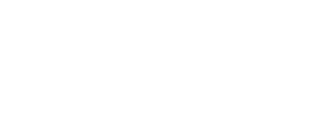 A light-colored wooden table featuring an open book and a small, vibrant green houseplant in a blue ceramic pot.