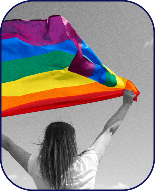 A LGBTQ woman waving a rainbow flag