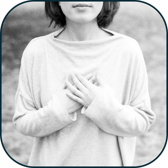 A woman with her hands on her chest to represent relief from anxiety