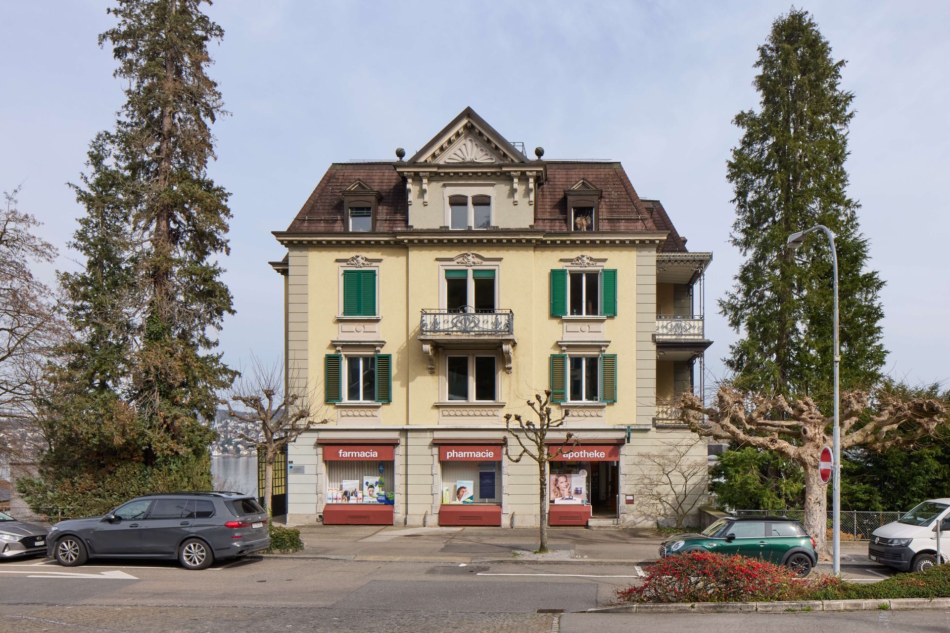 Ein grosses Gebäude mit davor geparkten Autos