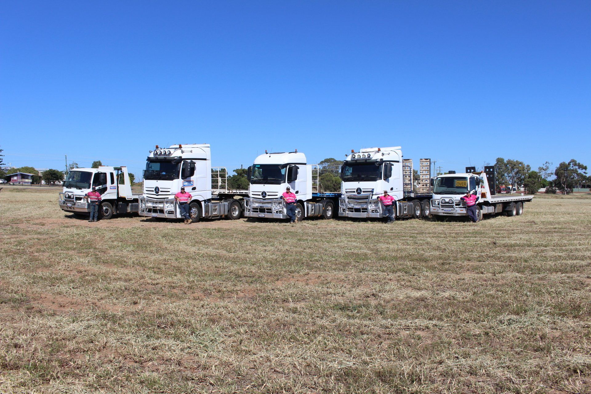 Men in front of the Trucks — Transport & Equipment Hire in Moranbah, QLD