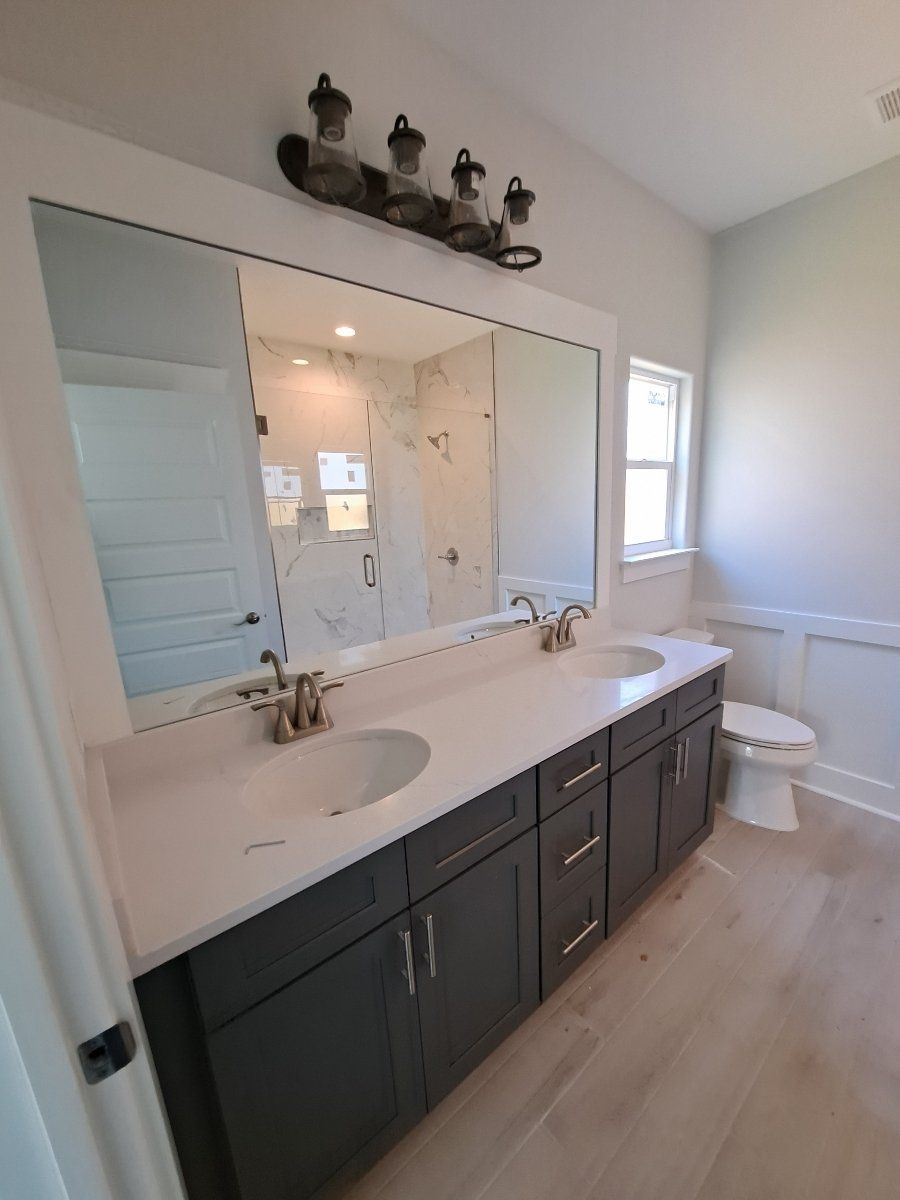 dark wood bathroom vanity and double mirrors
