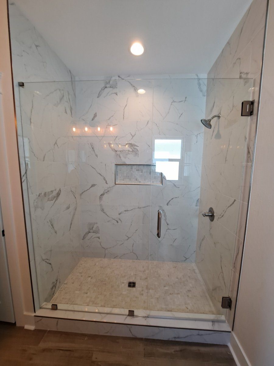 modern shower surround with glass door and fixed glass panel