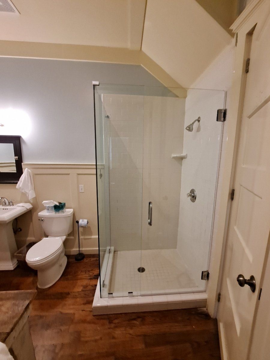 bathroom with wood paneling and glass shower enclosure