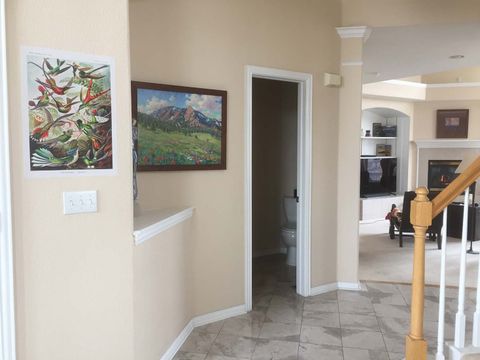 a hallway with a picture on the wall and stairs