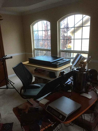 a room with a scanner on a table in front of a window