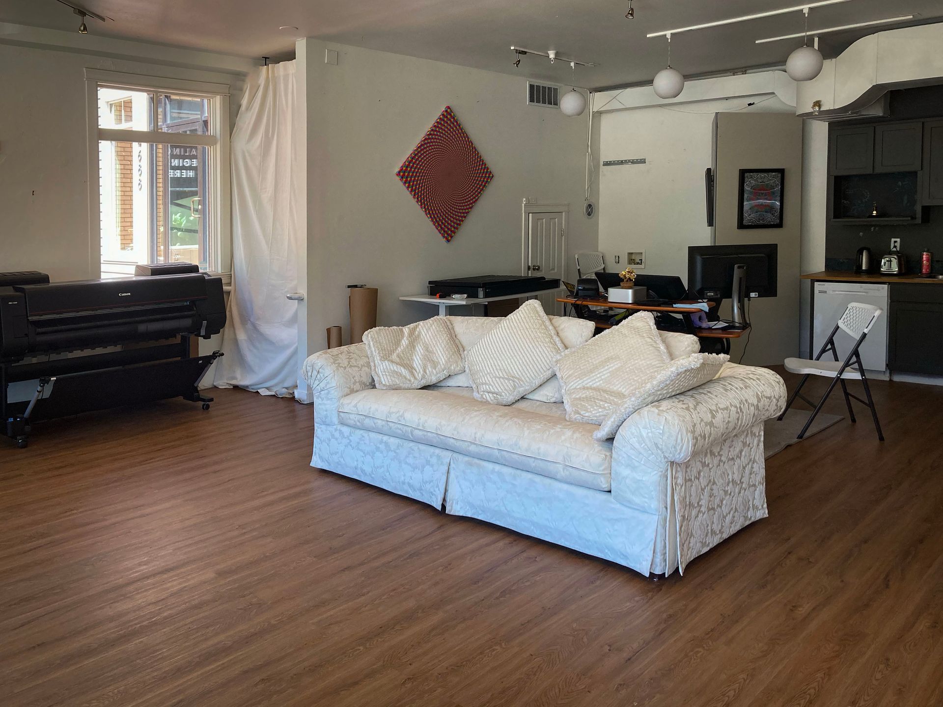 An art studio with a white couch and chairs