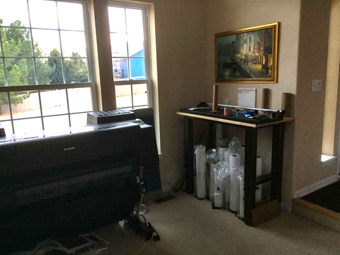 a room with a piano and a painting on the wall