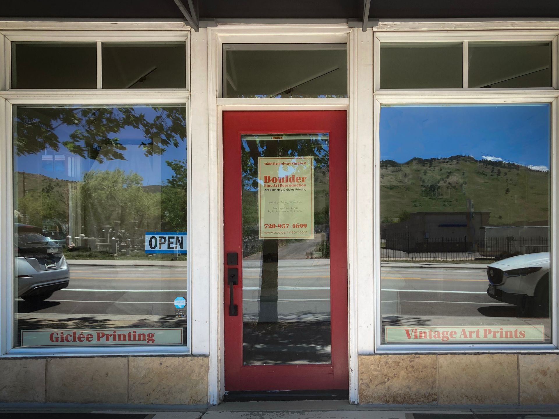 A red door with a sign on it that says open