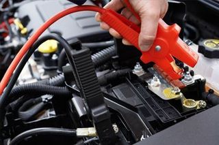 Jump-starts - Close-Up Of Mechanic Attaching Jumper Cables To Car Battery in Mesa, Arizona
