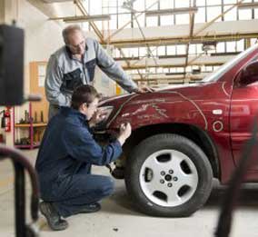 tires - Mechanics checking damaged automobile in Mesa, Arizona