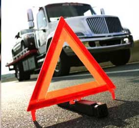 Emergency Services - Safety triangle on highway near tow truck in Mesa, Arizona