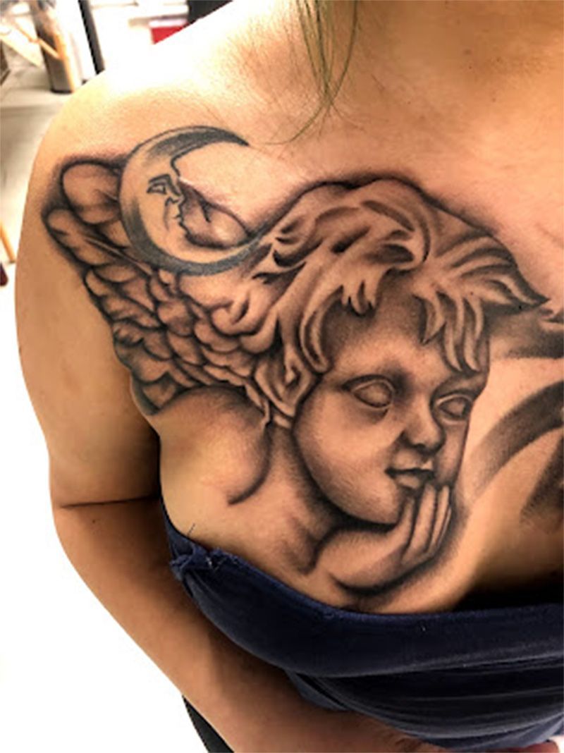 A woman has a tattoo of an angel on her chest