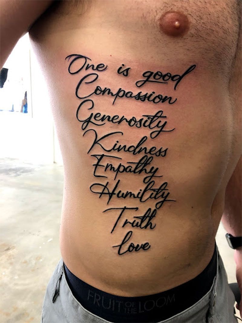 A man has a tattoo on his side that says one is good compassion generosity kindness empathy humility truth love
