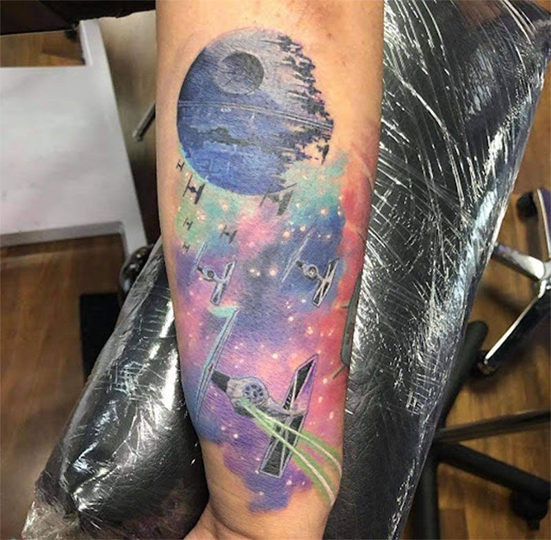 A person has a star wars tattoo on their arm