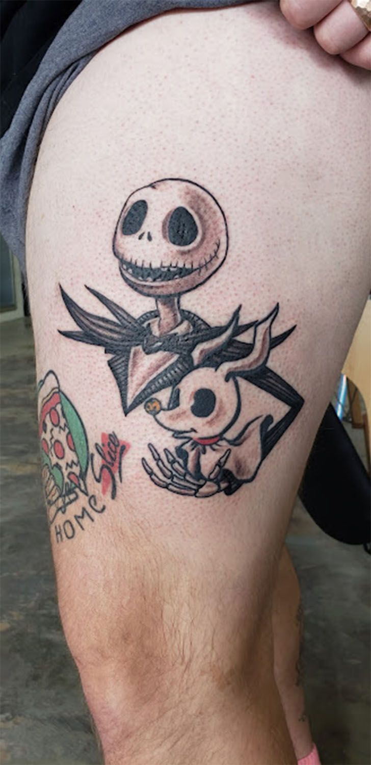 A person has a nightmare before christmas tattoo on their thigh.