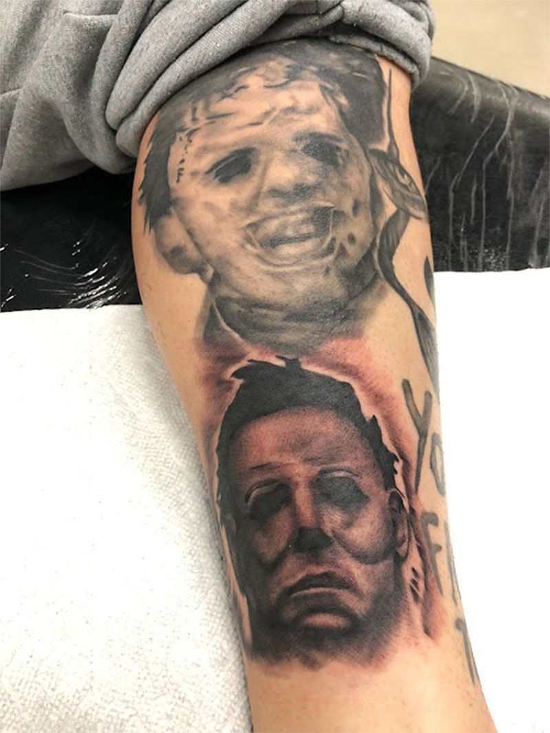 A person has a tattoo of two faces on their arm.