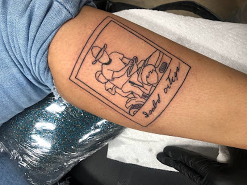 A person has a tattoo on their arm that says smoke eater