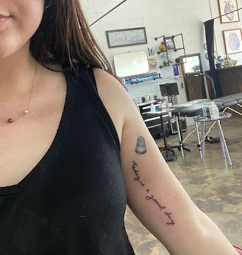 A woman has a tattoo on her arm that says today is a good day