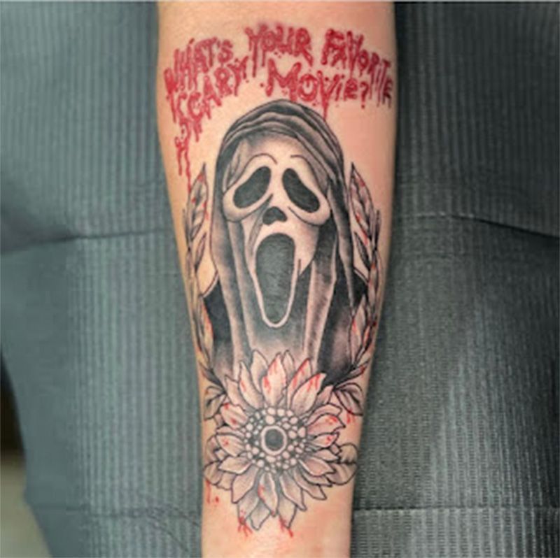 A person has a scream tattoo on their forearm
