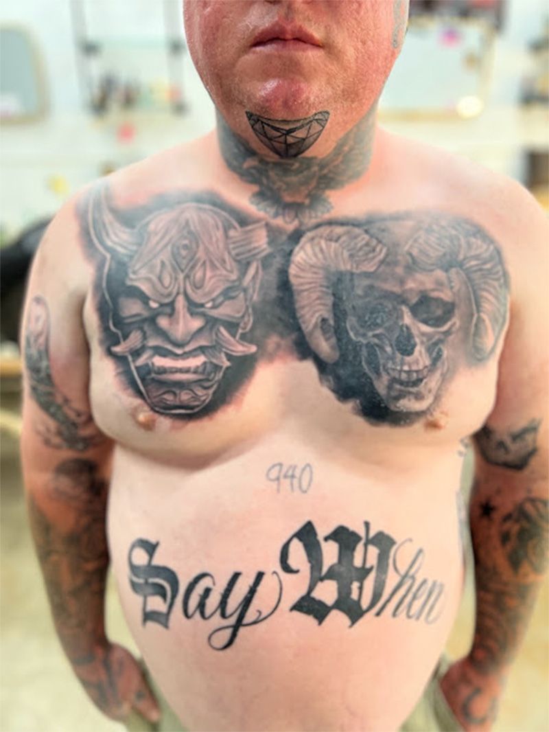 A man has a tattoo on his chest that says say when