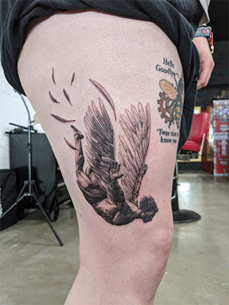 A person has a tattoo of an angel on their thigh