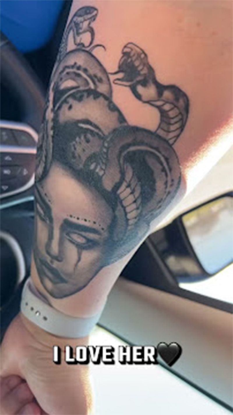 A person with a tattoo on their arm that says `` i love her ''.