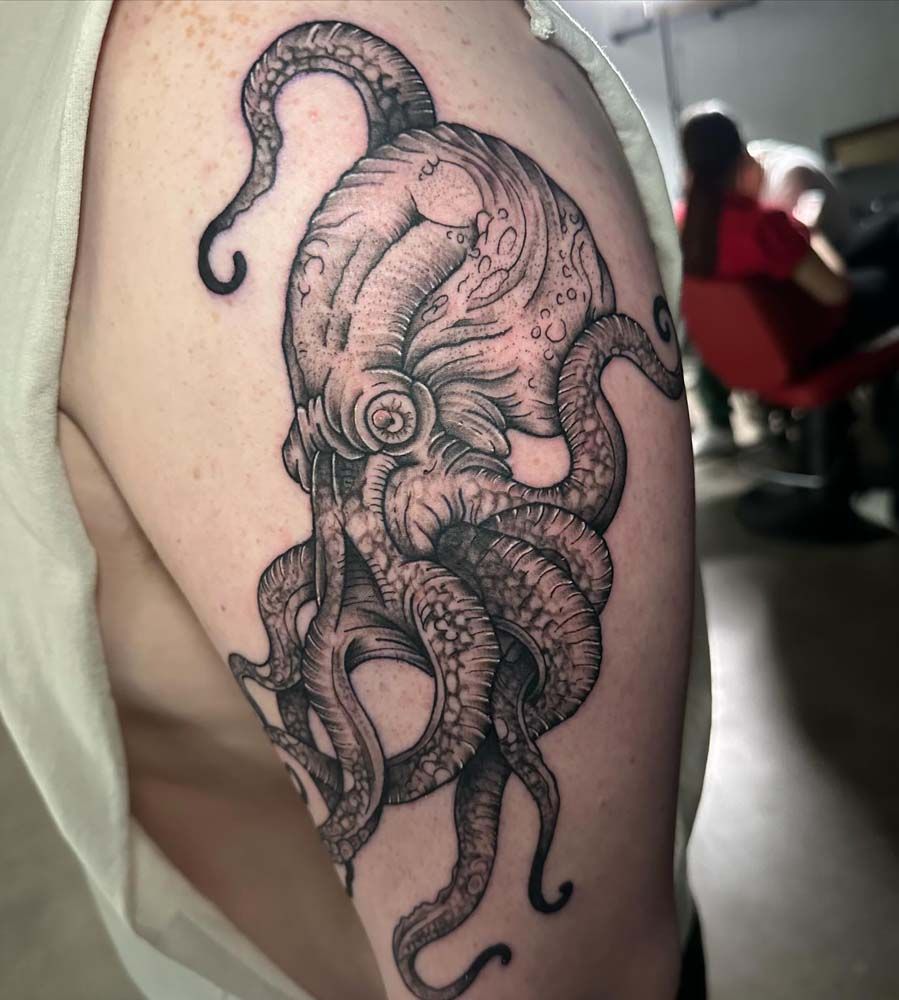 A man has a tattoo of an octopus on his arm